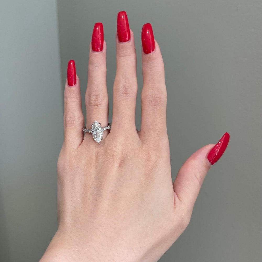 Marquise cut ring with round side diamonds