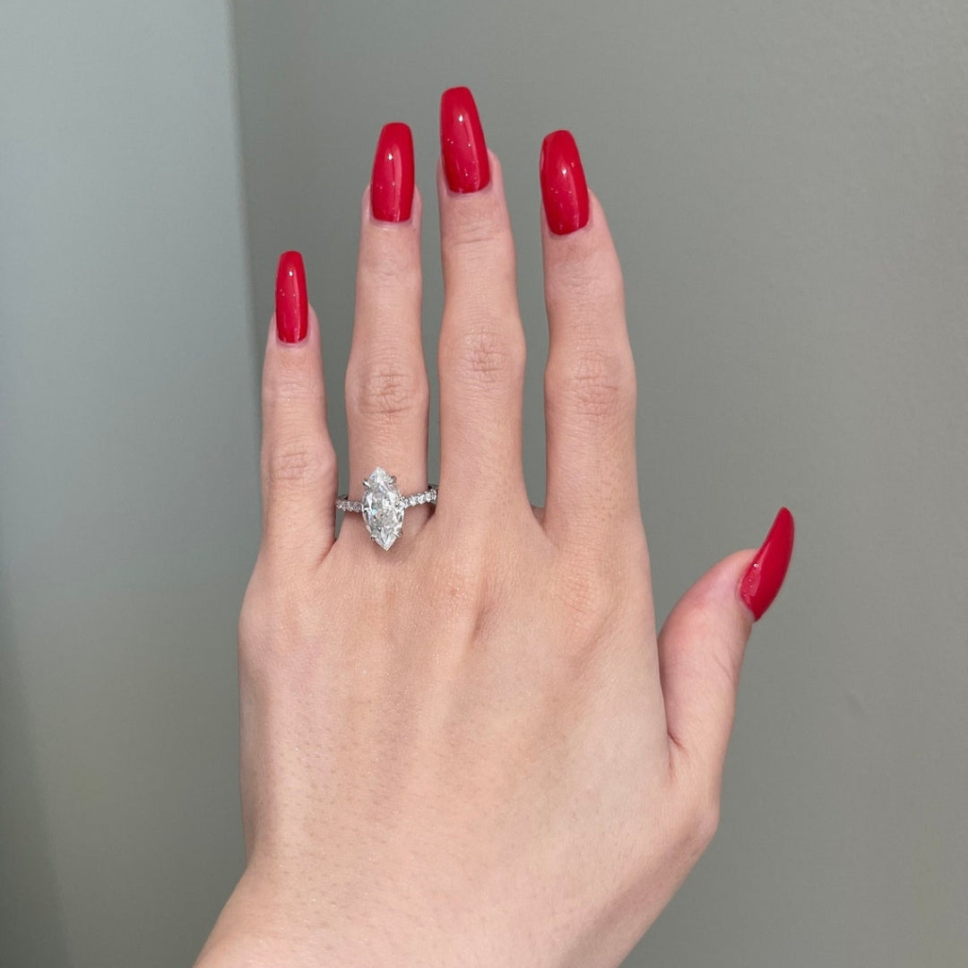 Marquise halo wth round side diamond ring
