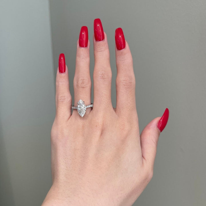 Marquise halo wth round side diamond ring