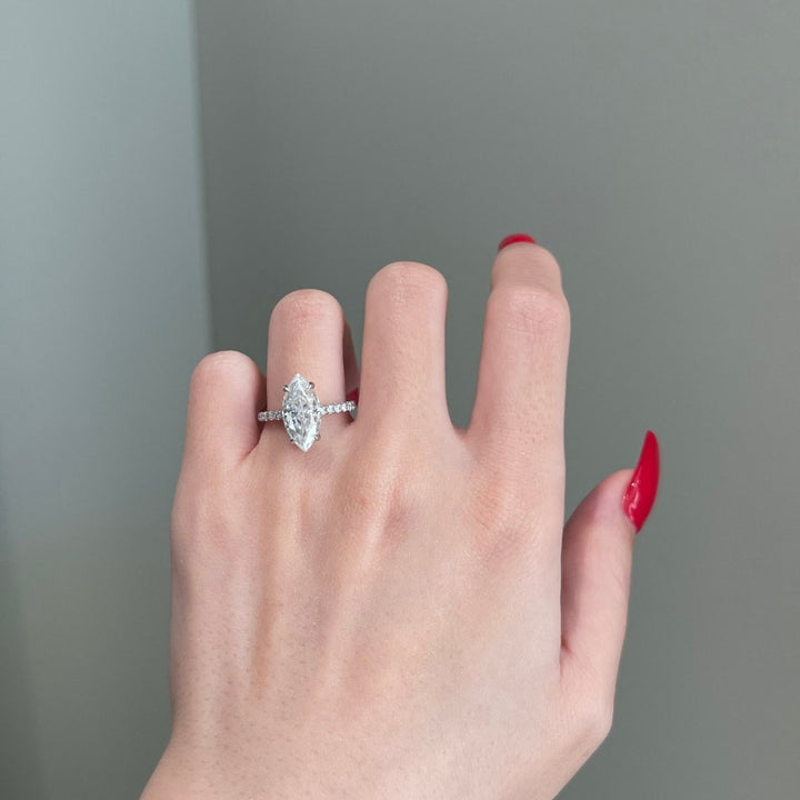 Marquise shape ring with round side stones