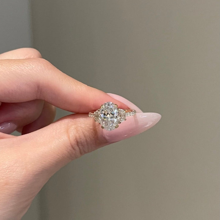 Oval diamond ring with side stones