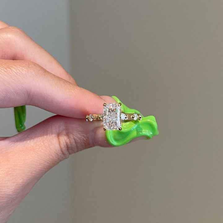 Radiant engagement ring with round accents