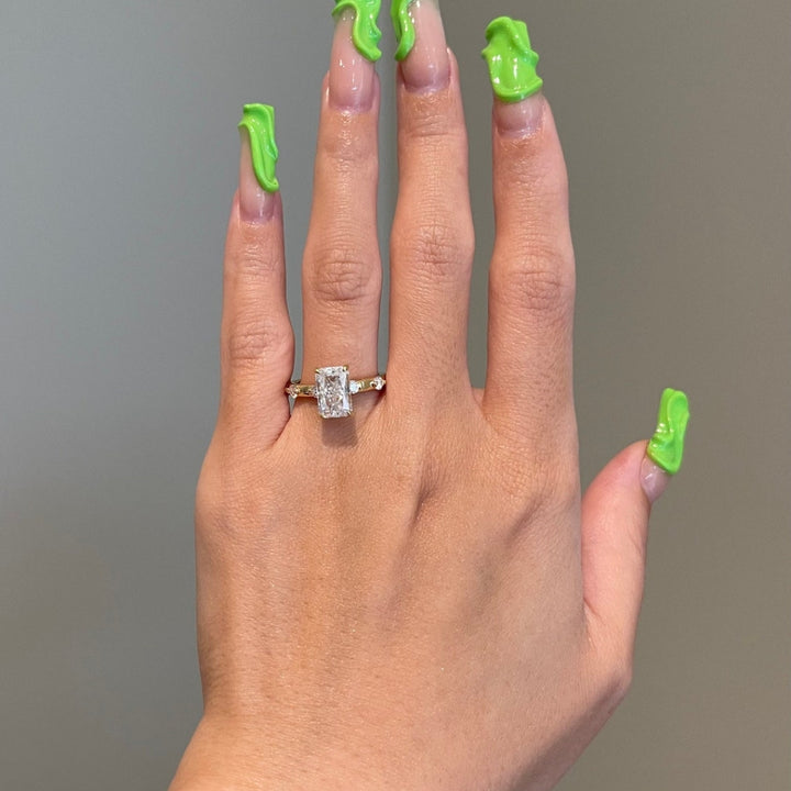 Radiant with round side stones hidden halo ring