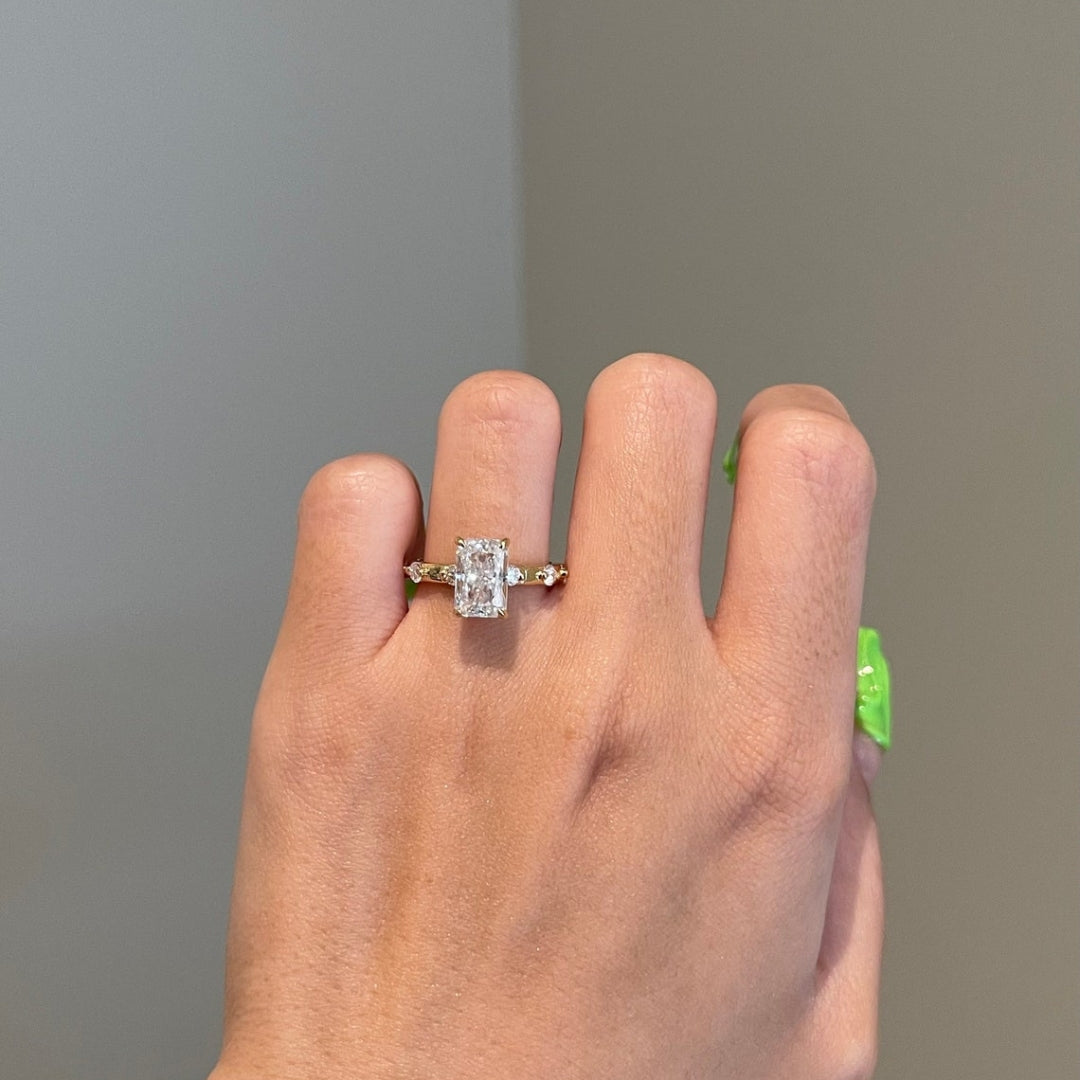 Radiant cut solitaire with side stones hidden halo