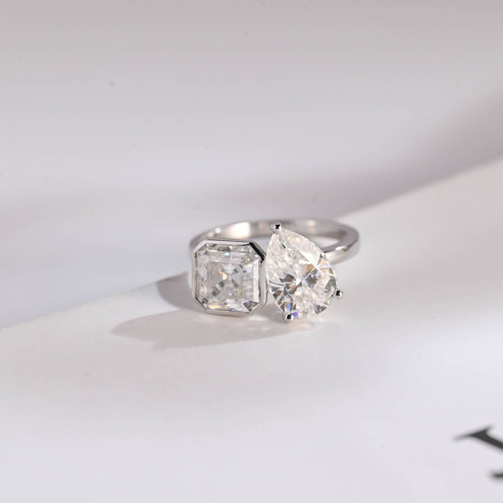 Asscher cut diamond ring with pear side stones