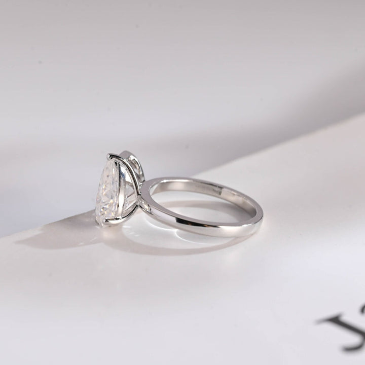 Asscher cut ring with pear side ring
