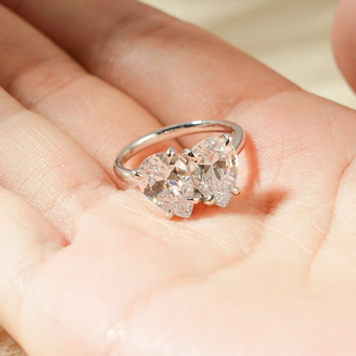 Floating pear diamond ring