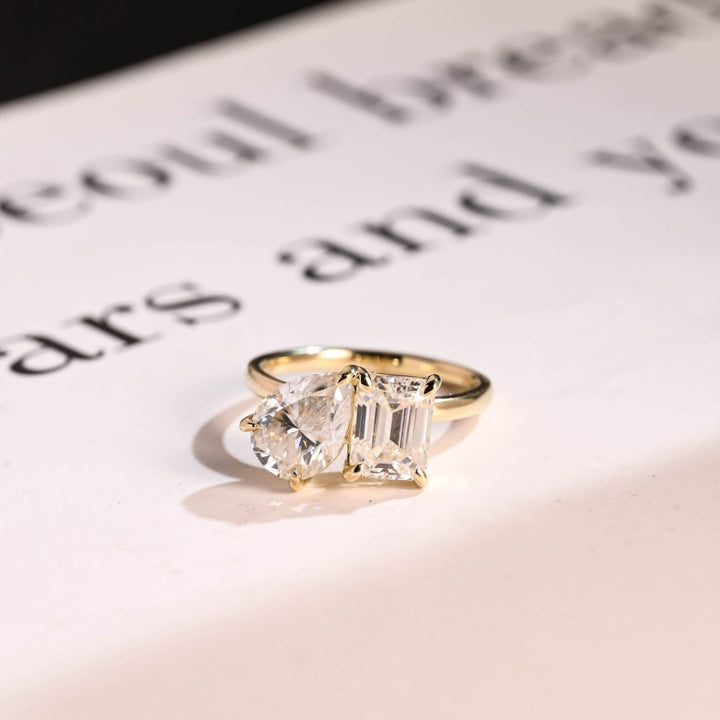 Pear diamond and emerald two stone ring