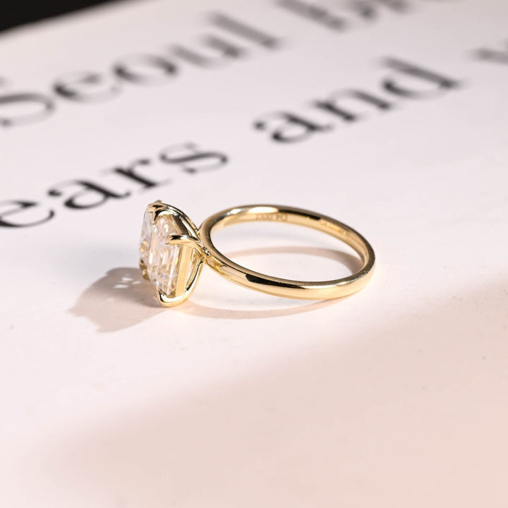 Pear shaped center stone ring emerald accents