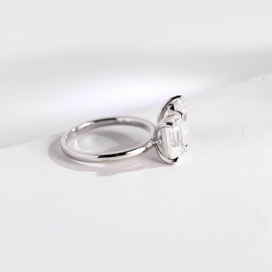 Pear cut engagement ring with emerald accents