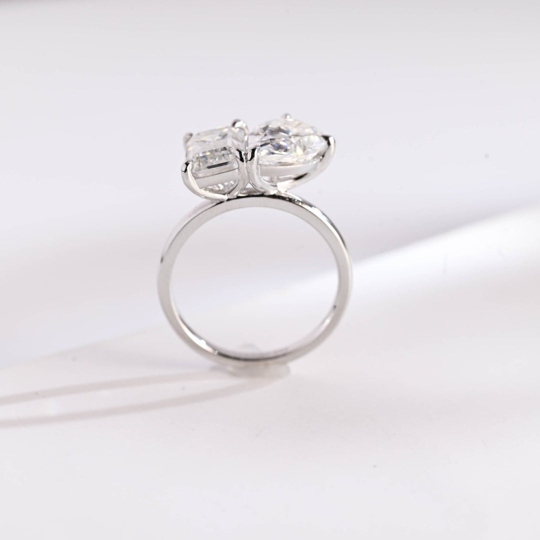 Pear solitaire ring with emerald side stones
