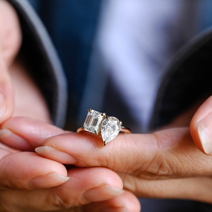 Pear shaped moissanite  ring with emerald side stones