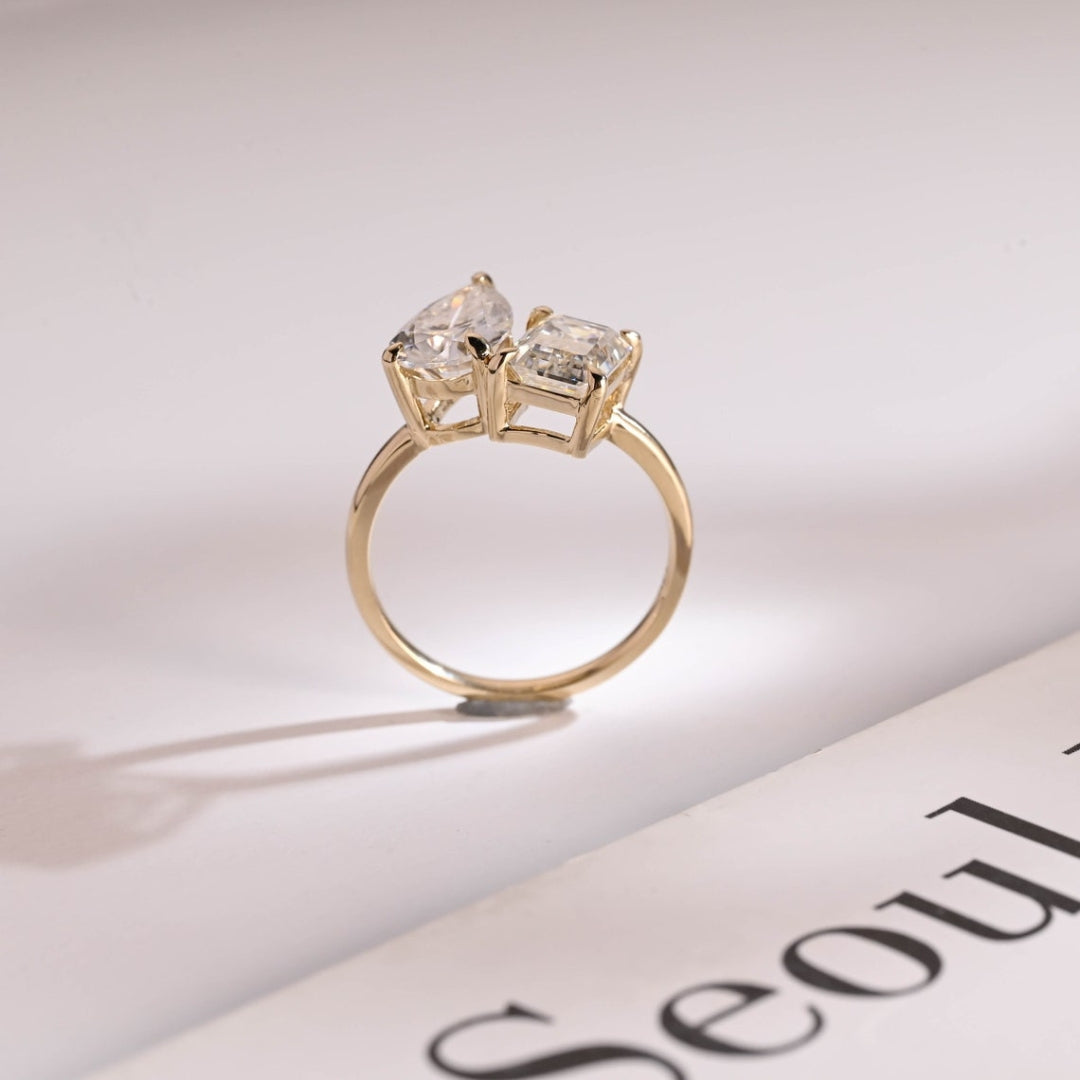 Pear diamond and emerald two stone ring