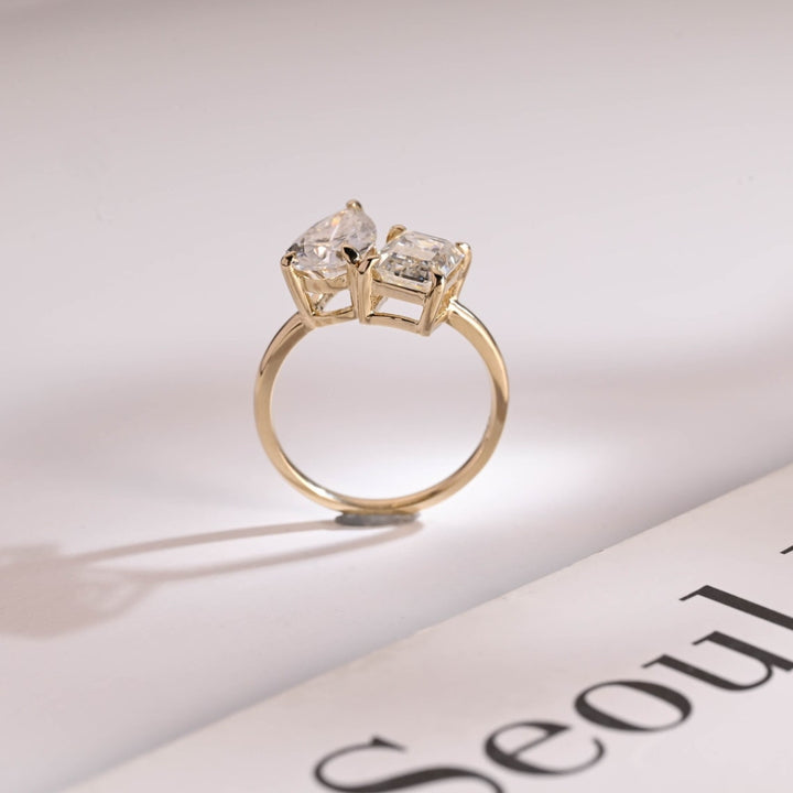 Pear diamond and emerald two stone ring