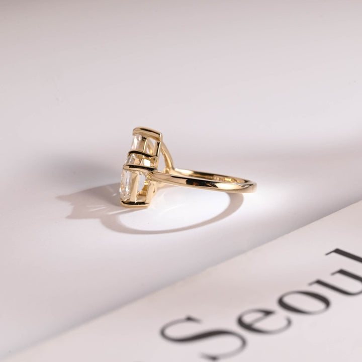 Pear shaped center stone ring emerald accents