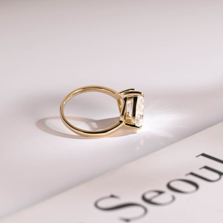 Pear emerald side stone engagement
ring