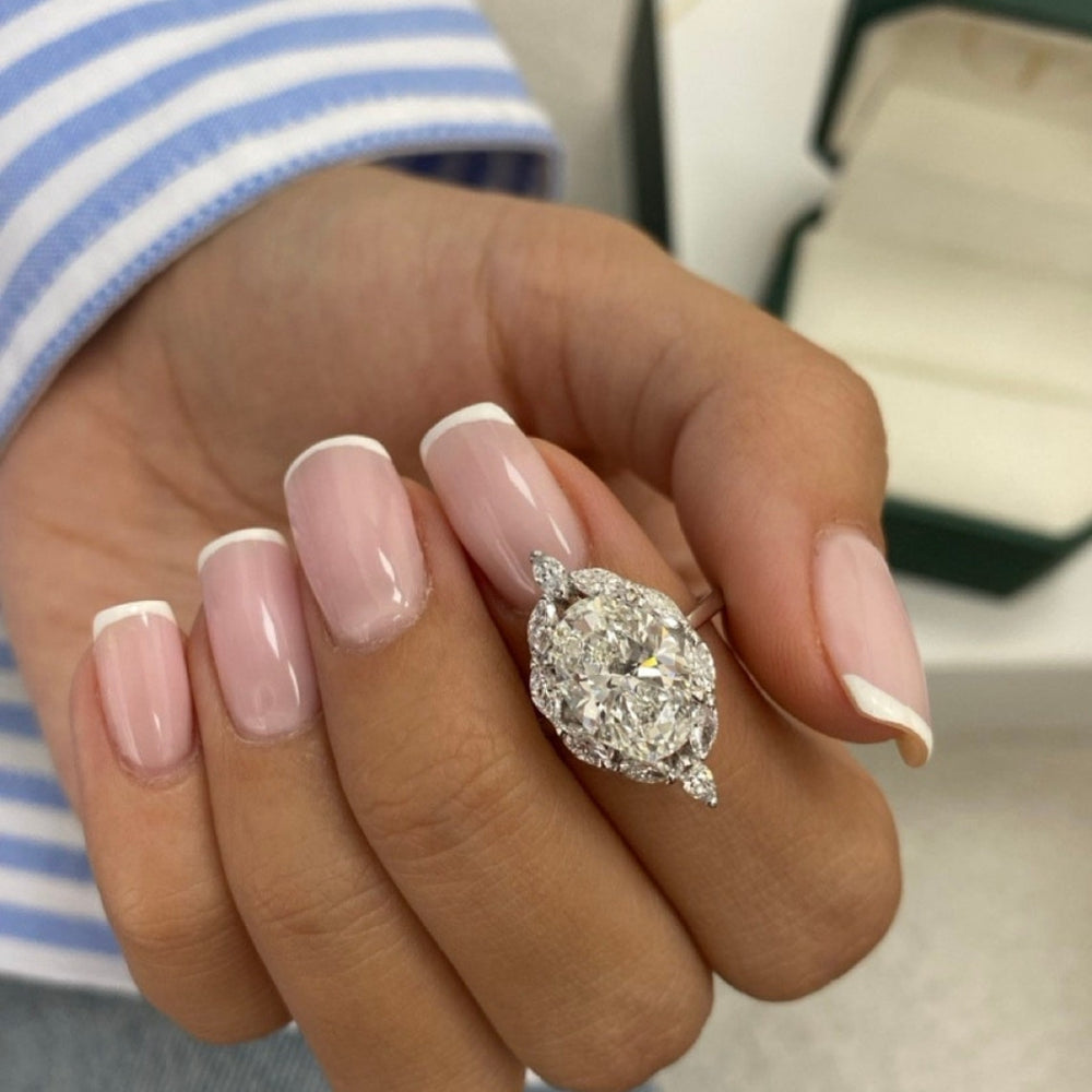 Oval white stone ring with marquise side stone