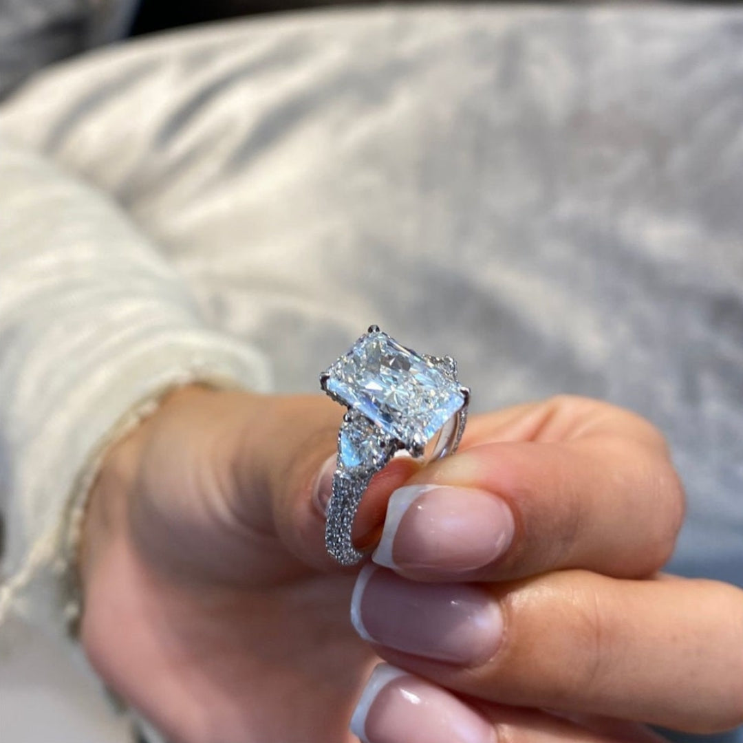 Radiant hidden halo ring with half moon side stone