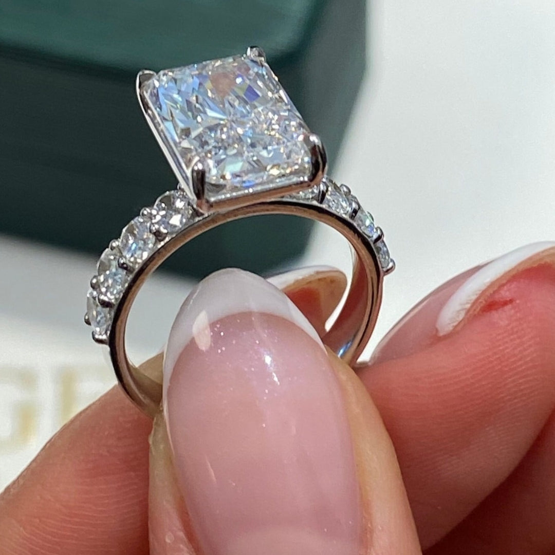Radiant diamond ring with round accent stones