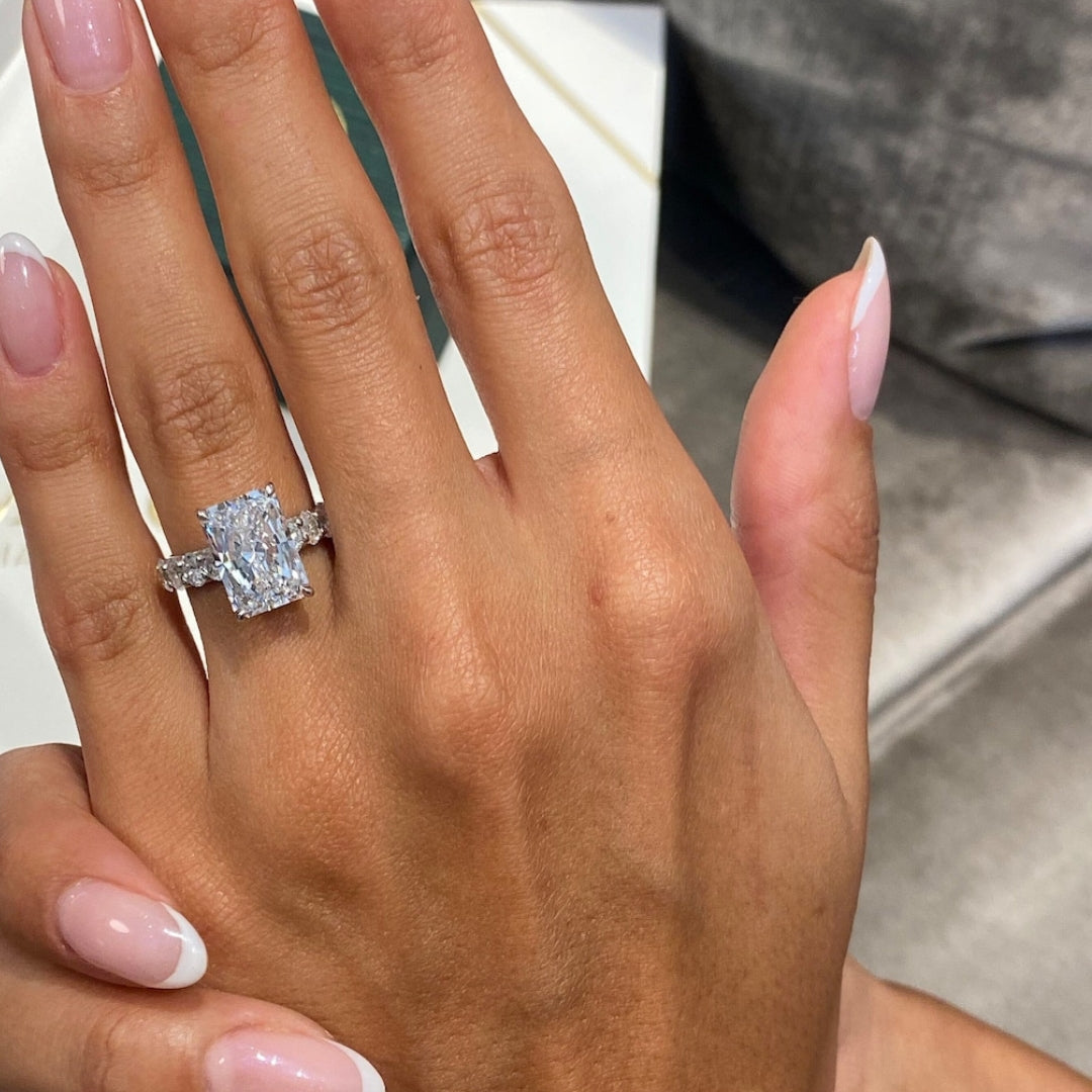 Radiant solitaire with round side stone ring