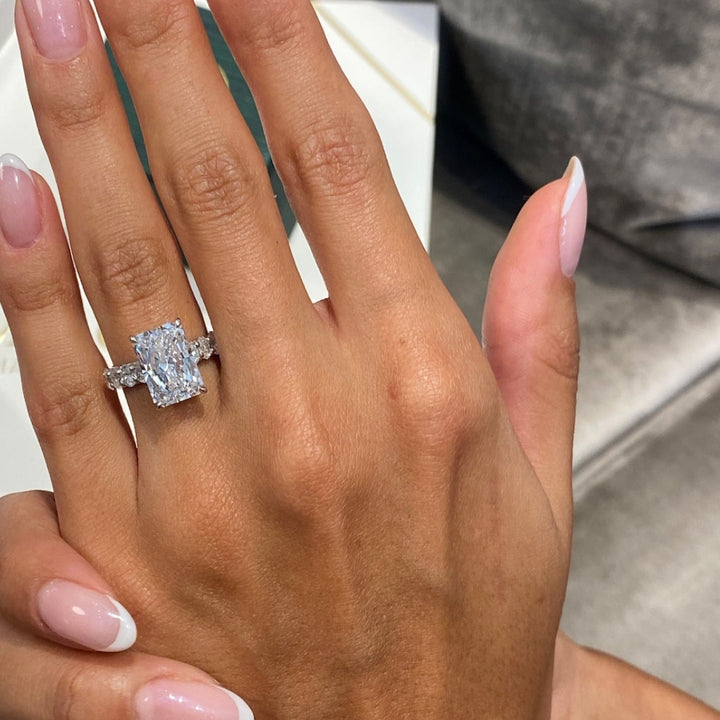 Radiant solitaire with round side stone ring