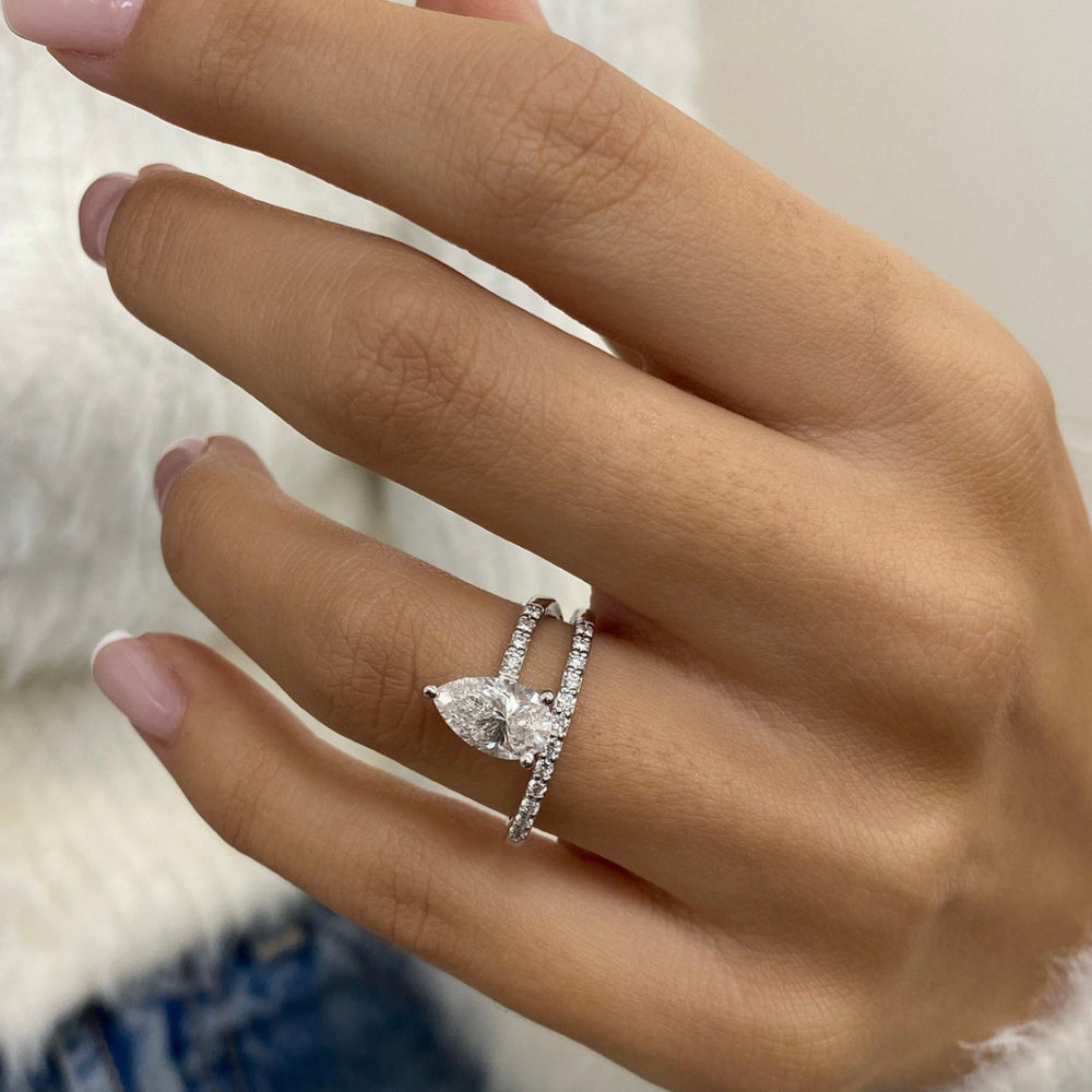 Pear shaped halo with round stone ring