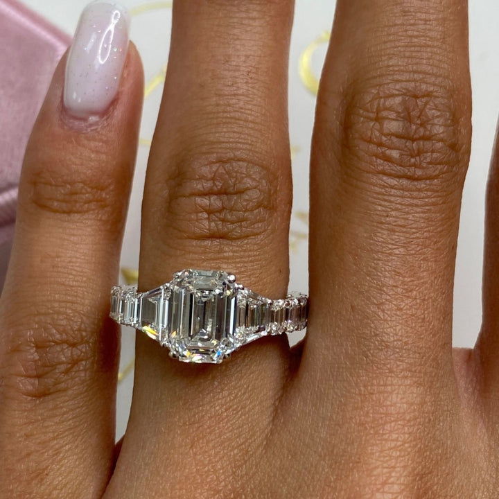 Emerald center ring with trapezoid side stones