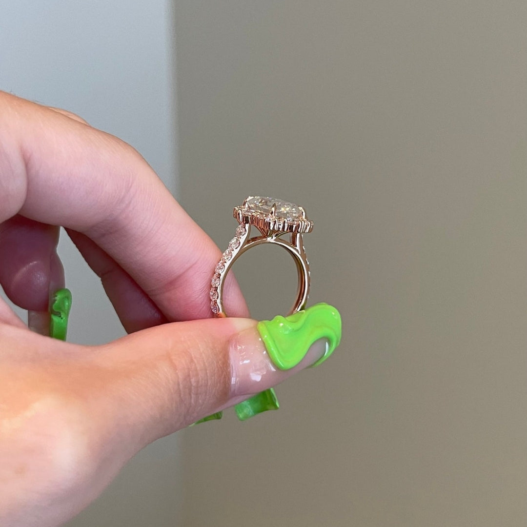 Emerald diamond ring with round side diamonds