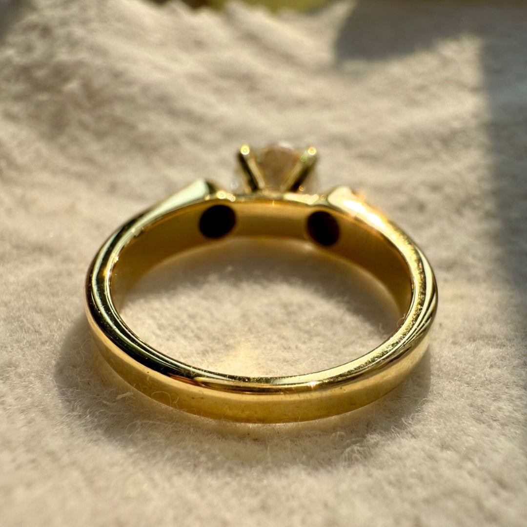 Yellow gold diamond ring with black side stone