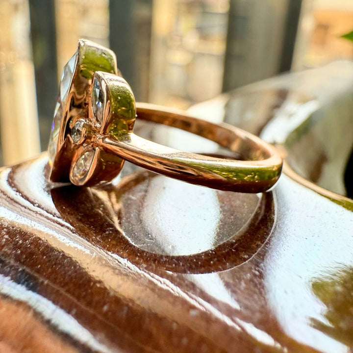 Marquise cut ring with round side diamonds