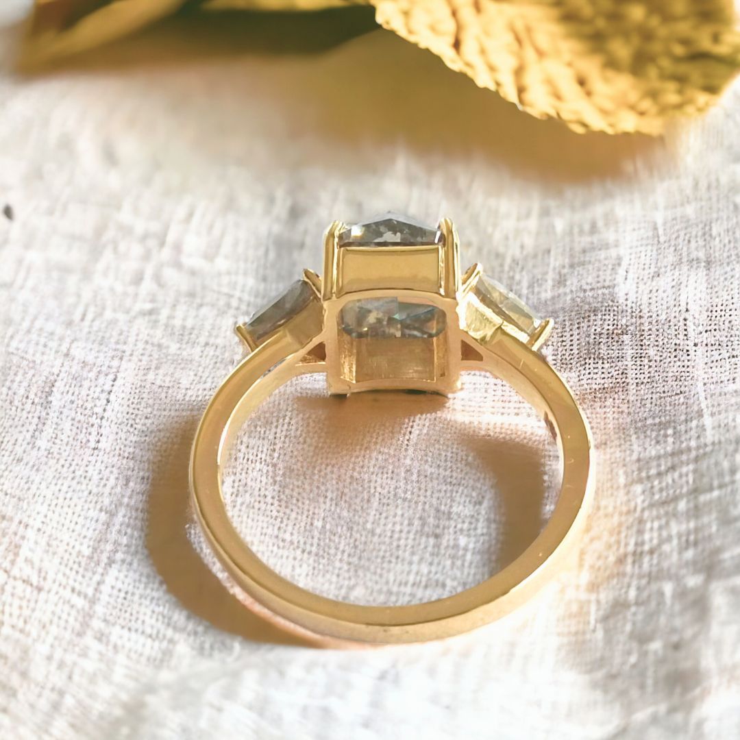 Radiant diamond ring with triangle side stone