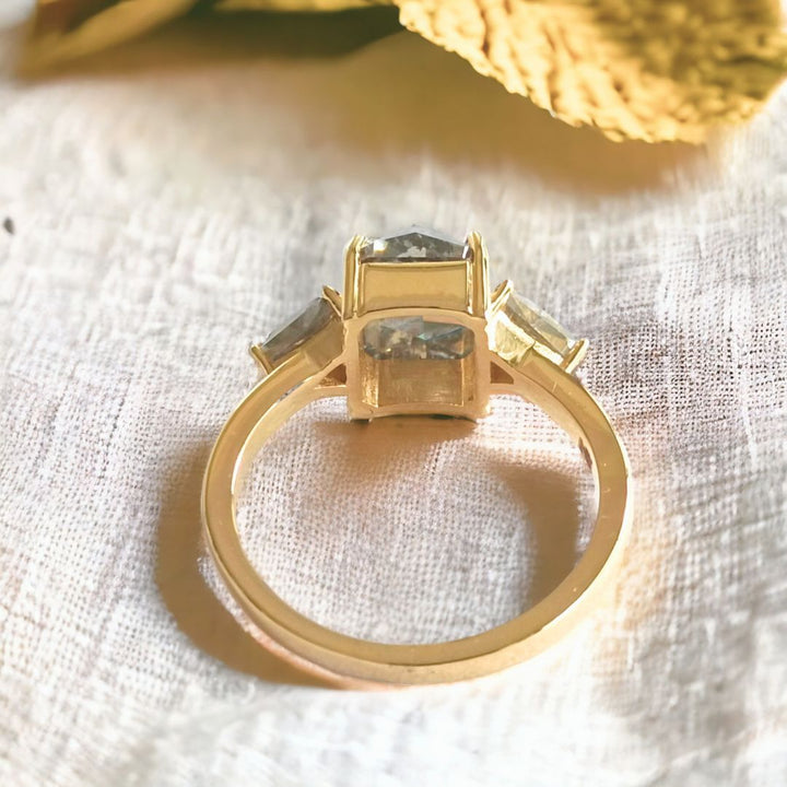 Radiant diamond ring with triangle side stone