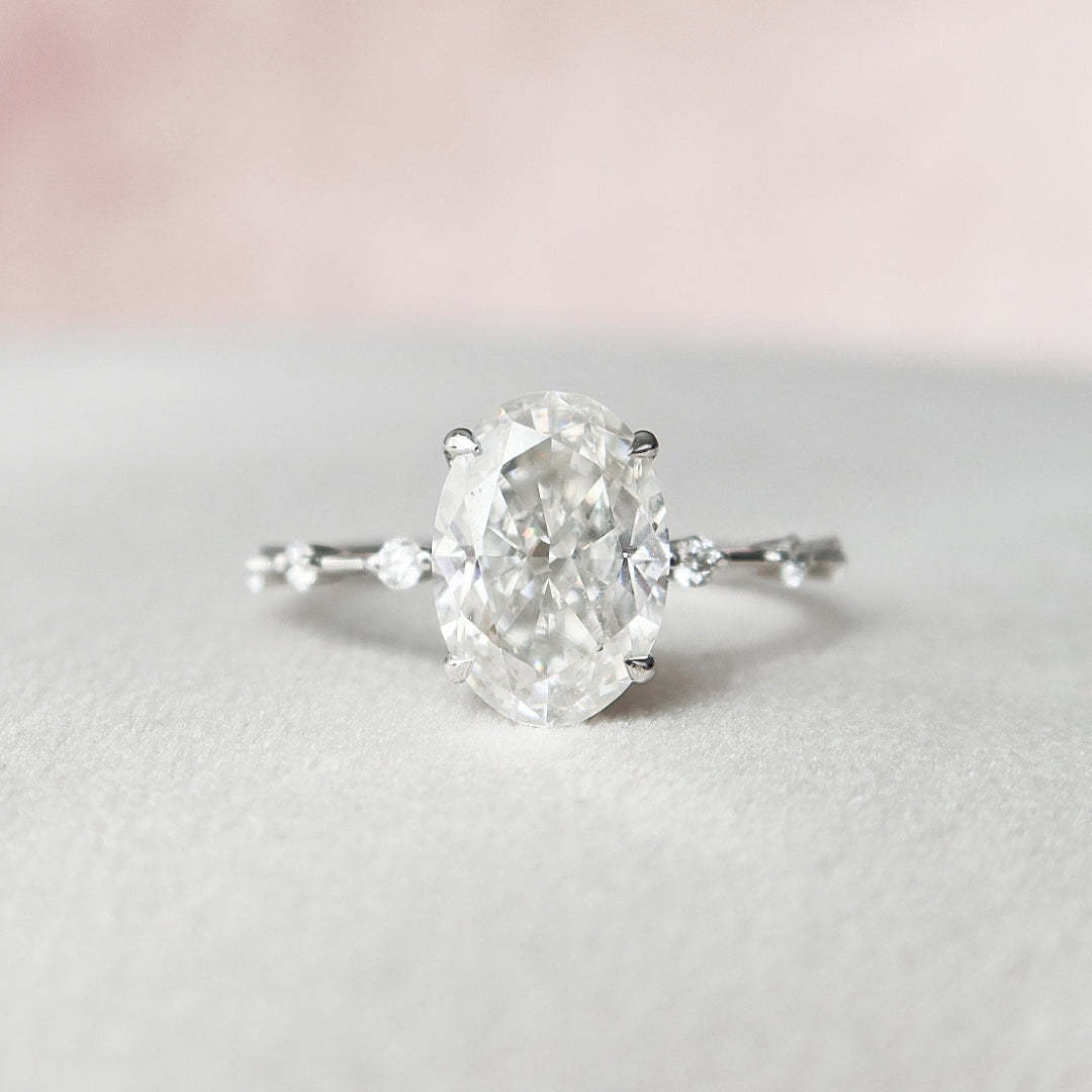 Oval engagement ring with side stone round